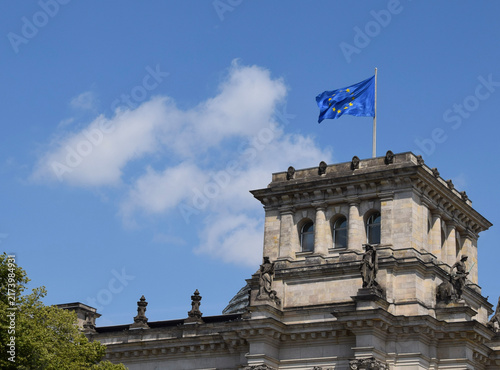 Принти на полотні Waving European Union Flag on a Rooftop Against a Cloudy Sky in Berlin, Germany
