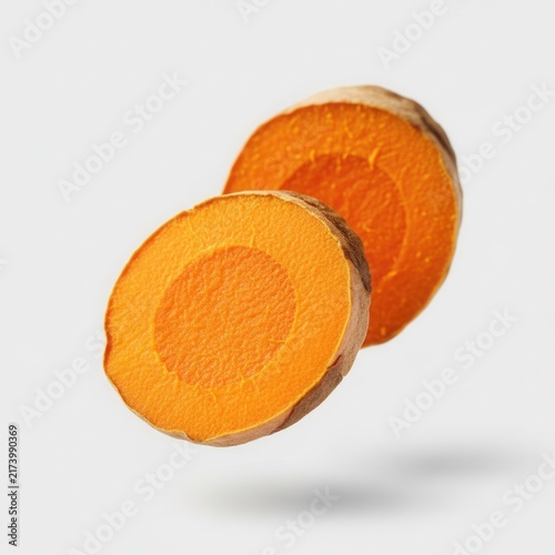Vibrant Turmeric Root Slices Isolated On White Studio Background