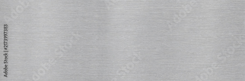 Fotografie Brushed aluminum metal texture background, horizontal silver stainless steel surface with fine linear grain, industrial metallic plate backdrop for modern tech design and web banners