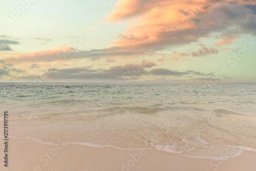 Tranquil pastel sunset calm sea soft glowing sky tropical beach shore evening light gentle ocean water. Peaceful summer nature seascape meditation wellbeing. Relaxing coastal inspiring wallpaper scene
