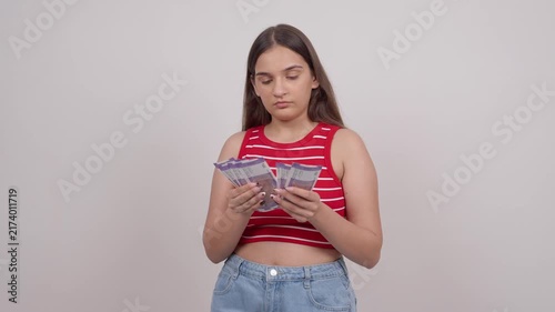 Indian Teenage Girl Counting 100 Indian Rupee Notes