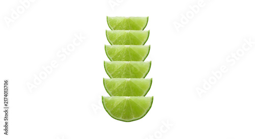 Fresh green lime fruit wedges stacked vertically in a line on black background