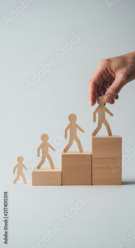 Wooden Figures Progressing on Stacked Blocks Symbolizing Growth