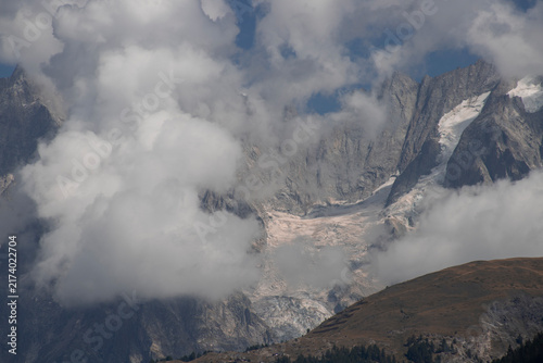 Clouds shrouding towering peaks of mont blanc massif
