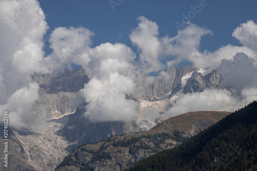 Mont blanc massif peaks emerging from alpine clouds