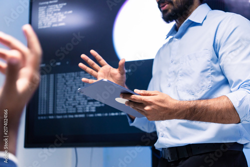 Software engineer use digital tablet Presenting system cyber security or coding on computer screen at home office. Professional programmer working use technology AI verify code or reading data develop