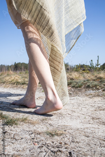 To walk on sand with your feet. Dryness. Wind. Steps. Woman relaxing on the beach.