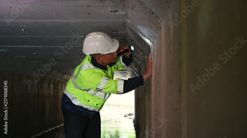 Maintenance Engineer Examining Underground Drainage System and Water Infrastructure