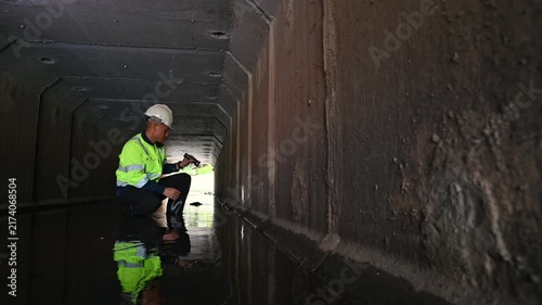 Maintenance Engineer Examining Underground Drainage System and Water Infrastructure