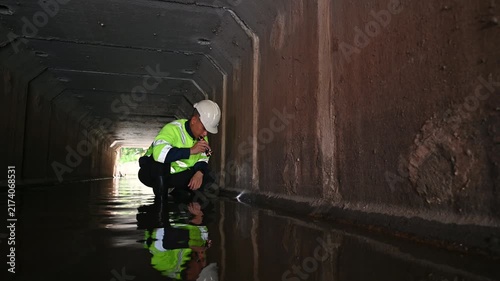 Maintenance Engineer Examining Underground Drainage System and Water Infrastructure