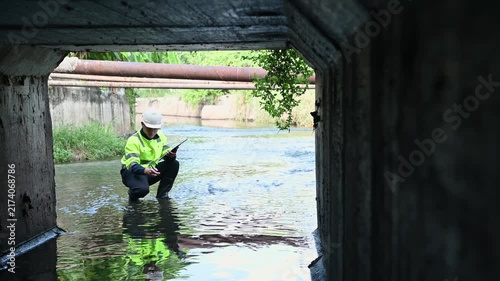 Engineer Conducting Infrastructure Inspection in Underground Stormwater Drainage Channel