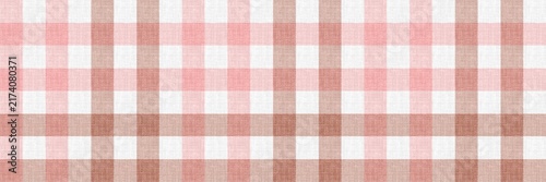 Pink and brown gingham check pattern background on textured fabric. Vichy pattern for autumn background. Classic checkered plaid pattern backdrop.