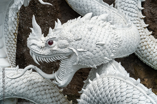 Фотография Intricate white dragon sculpture with red eyes and detailed scales
