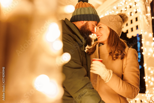 Couple drinking hot mulled wine at Christmas market