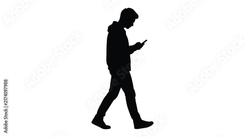 Black silhouette vector illustration depicting young man walking while using his mobile phone on white background