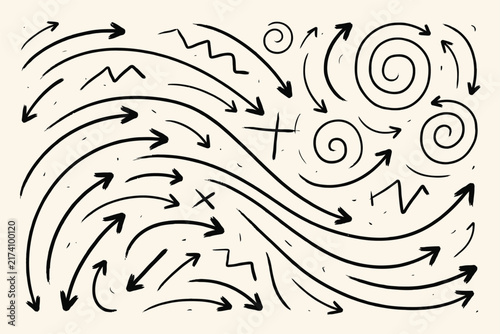Hand drawn black ink arrows collection on a beige background, various shapes and spiral doodle lines