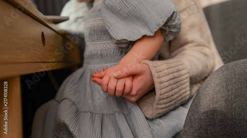Fotografie Mother and child holding hands, a tender moment of connection and love