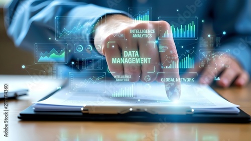 A hand touching a digital interface displaying data management and analytics, with charts and graphs glowing in a futuristic presentation