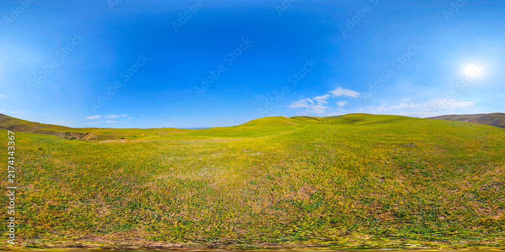 Obraz premium Vast Green Rolling Hills Under Clear Blue Sky Panorama