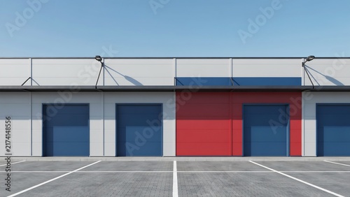 Modern industrial storage units with colored garage doors in a wellmaintained parking area under clear sky