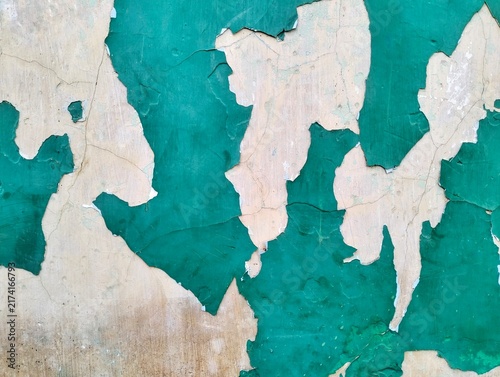 Peeling green paint on vintage concrete wall background texture
