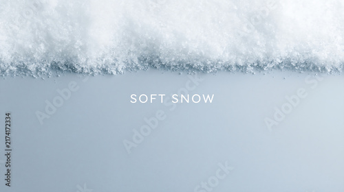 Soft fluffy snow border on a light blue background. Minimalist winter