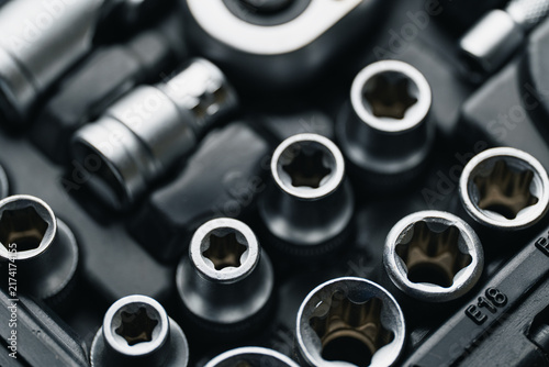 Professional mechanics socket set and screwdriver bits in organized toolbox case. Auto repair tool kit, hardware equipment, garage workshop tools background.