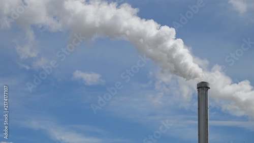 Smoke from chimney aganist a blue sky