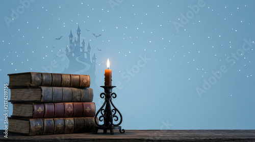A stack of old books and a burning candle for halloween night