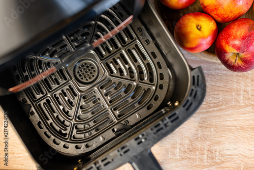 Top view of a clean empty metal grid inside an open air fryer basket
