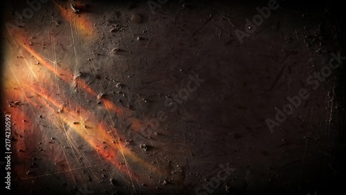 Dark, textured surface with glowing, fiery streaks and scratches