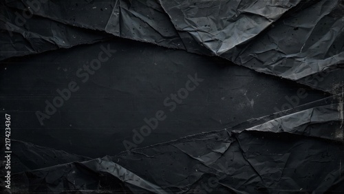 Jagged, creased dark material creates a ripped frame around a deep, shadowy void