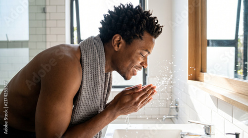 Dynamic Water Splash on the Face of an African American Man