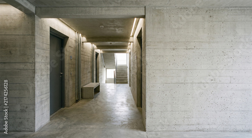 A framed residential passage reveals the austere geometry of raw concrete architecture