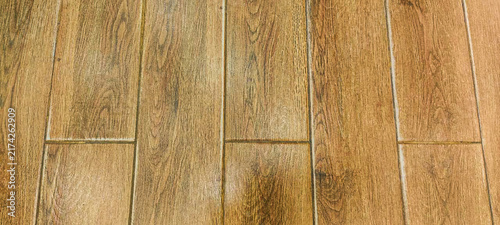 Brown oak wood floor texture background with vertical wooden planks and laminate tile pattern