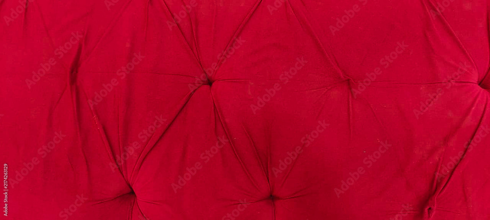 Obraz premium Red velvet tufted fabric texture background with luxury upholstered furniture pattern