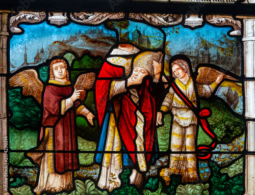 A stained glass panel depicts Saint Dionysius the Areopagite carrying his head between two angels.