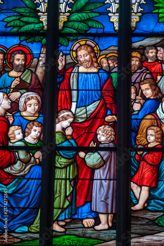 Принти на полотні A stained glass window depicts Jesus Christ surrounding himself with children