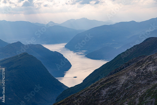 A beautiful summer  landscape with a ferry crossing Norddalsfjord. A summer scenery of World Heritage Area in Western Norway.