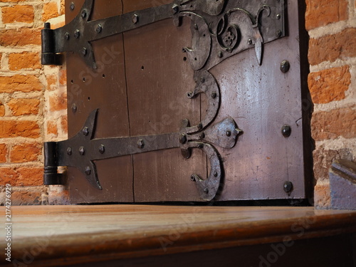 Fototapeta kuchenna Black iron hinges on the bottom of the door