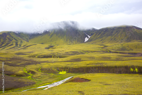 Exploring the green landscapes of Iceland in the highlands under cloudy skies