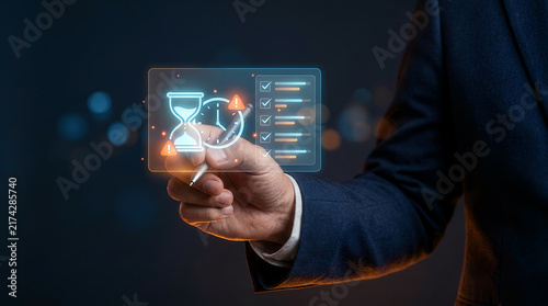 Hand with pen holding holographic hourglass loading icon