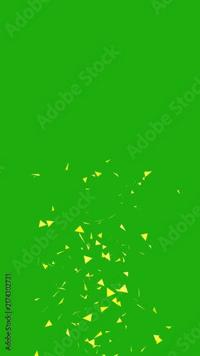 Yellow confetti particles rising on green screen for video compositing.