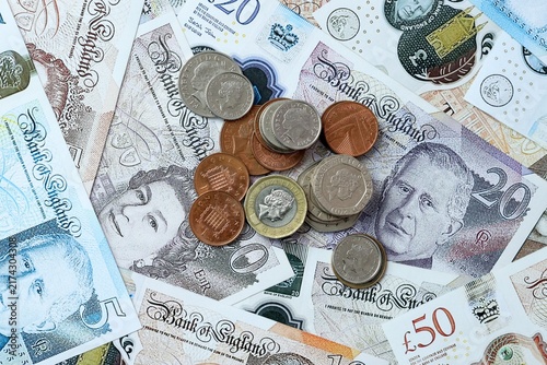 British pound money banknotes and coins on table. United Kingdom cash bills of GBP currency