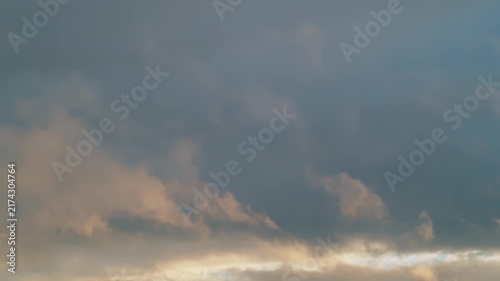Clouds changing colors over the horizon during early evening in a quiet area 