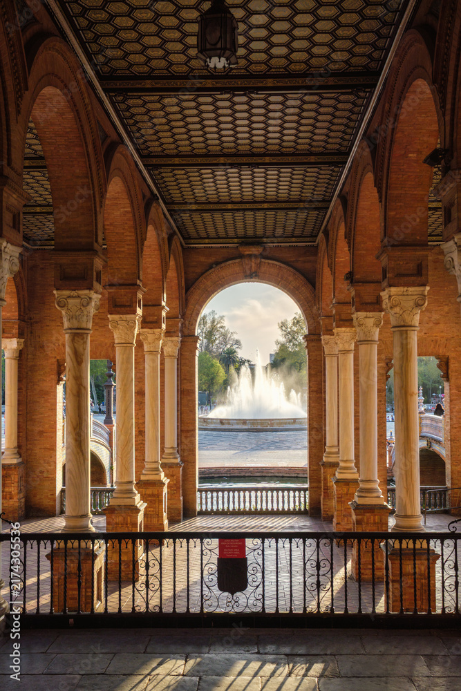 Naklejka premium View of the central fountain through arches at Plaza de Espana