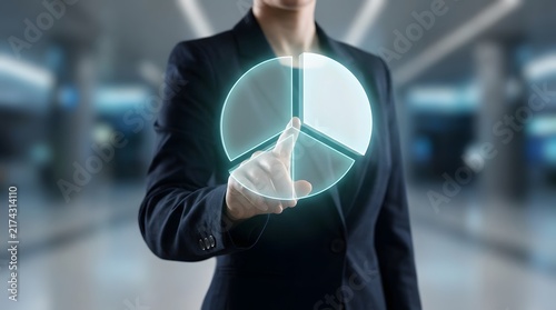 Businesswoman interacting with a digital holographic pie chart on a virtual interface