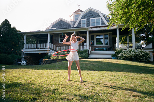 Young Girl with hula hoop in backyard film 