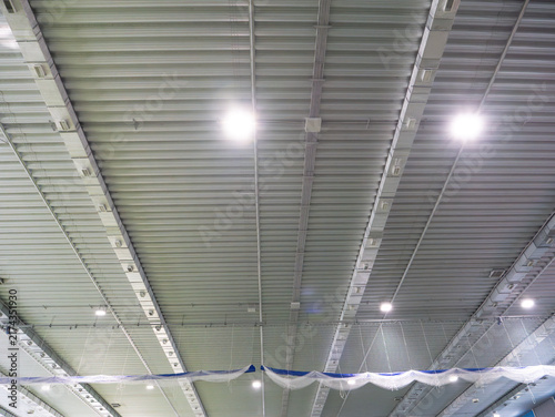 Illuminated metal ceiling inside an indoor sports arena