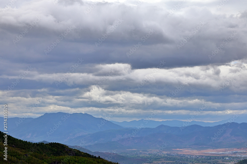 Fototapeta premium Mountain Range and Valley Under Overcast Sky